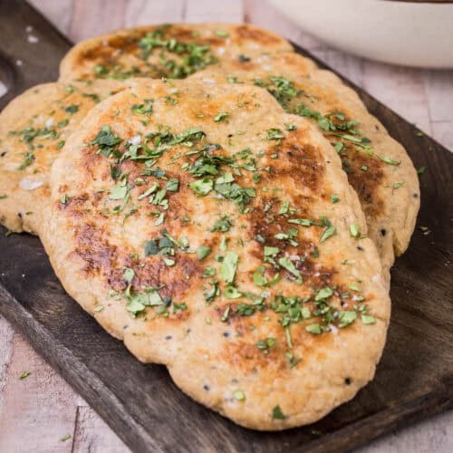Gluten-Free Naan Bread on wooden board with coriander
