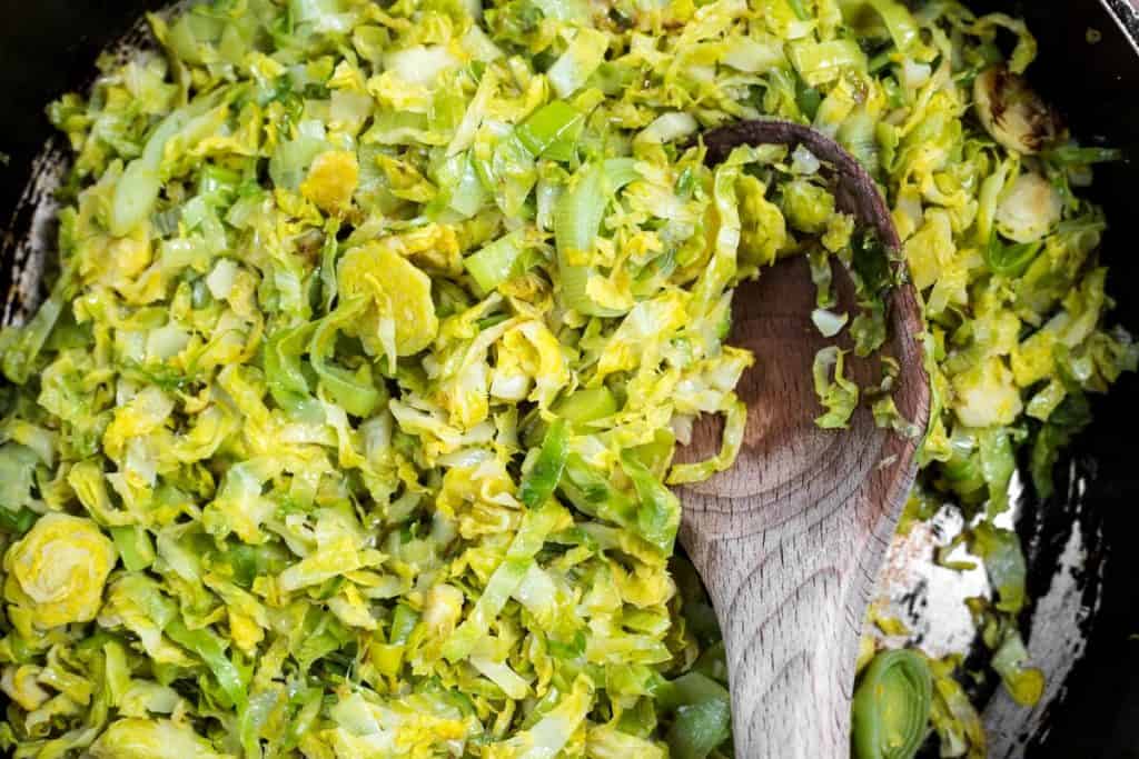 Brussel sprouts and leeks cooking in a pan