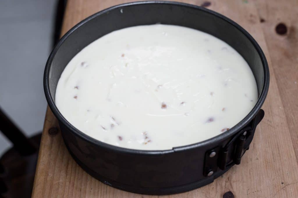 White Chocolate Ginger Cheesecake in a cake tin ready for setting