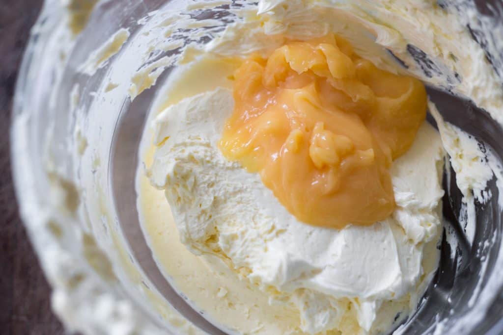 close up of lemon curd swiss meringue buttercream in a bowl