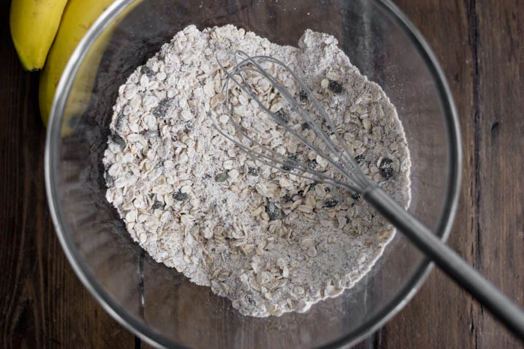 dry ingredients for banana oat bread in a glass mixing bowl