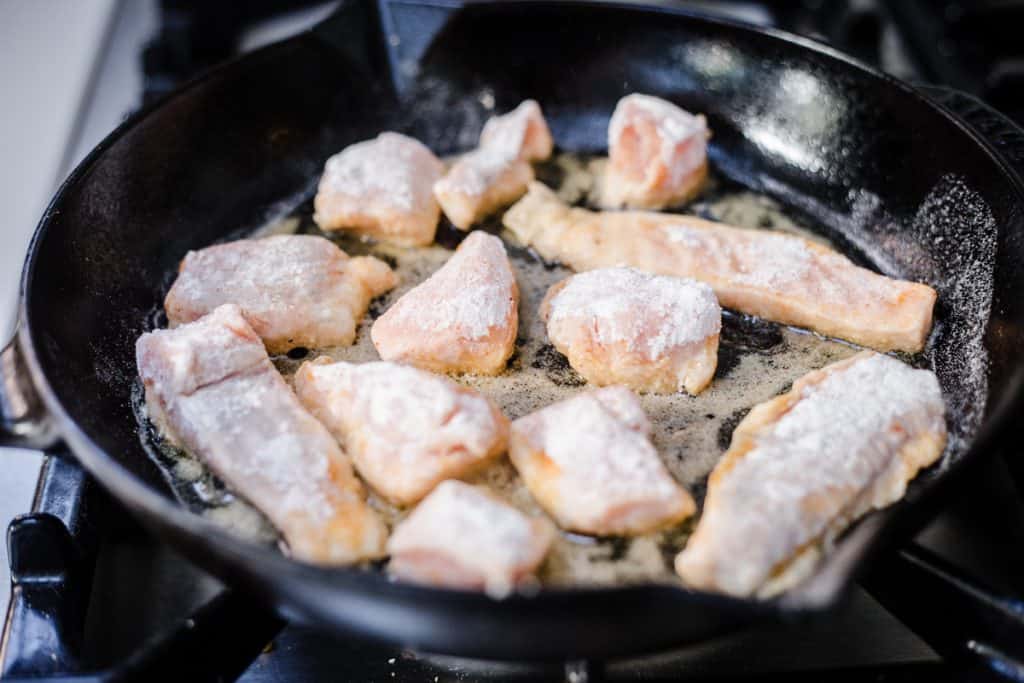 Salmon nuggets cooking in a pan