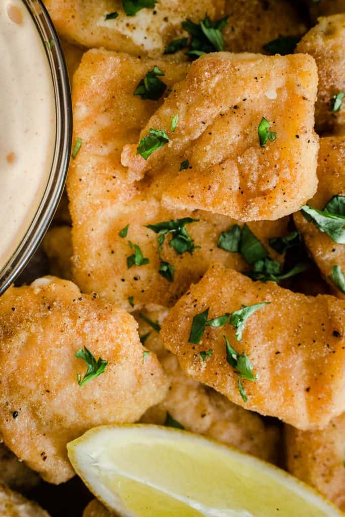 Close up of Salmon Nuggets on a plate with dipping sauce