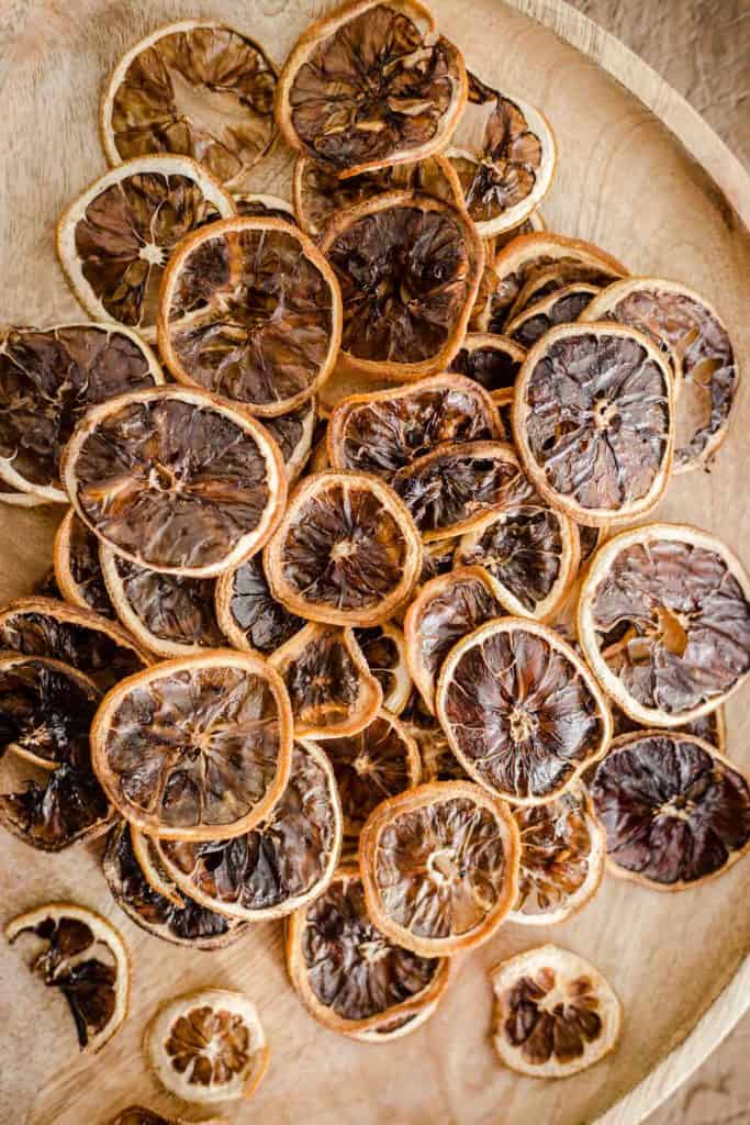 dried lemon slices on a wooden plate