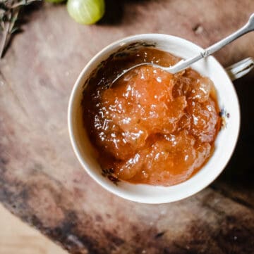 jam in a bowl with a spoon on a wooden tray