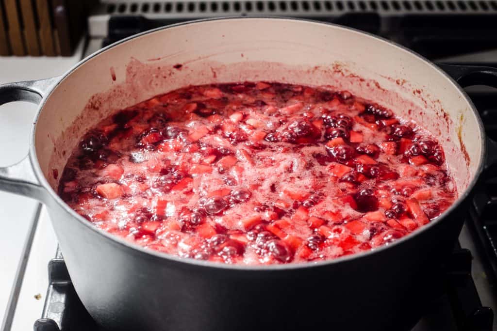 plum and beetroot chutney in a preserving pan cooking on a stove