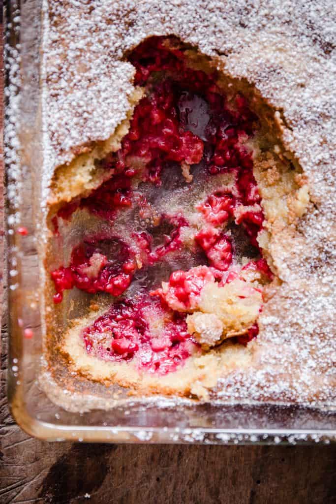 dish of raspberry pudding with a spoon taken out