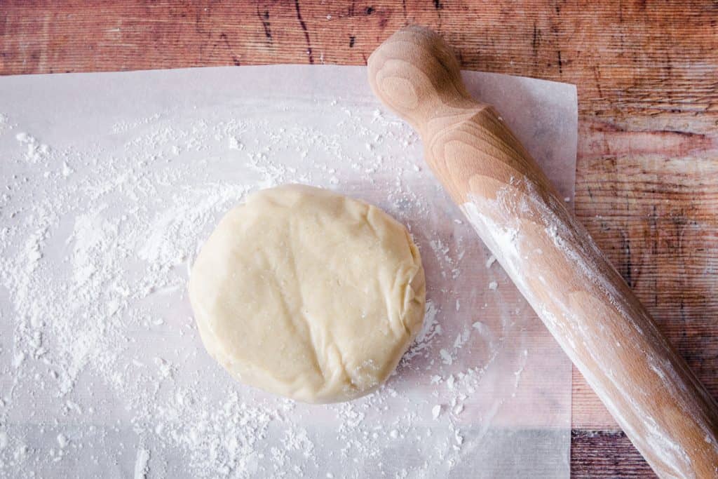 gluten free pastry on parchment paper next to wooden spoon
