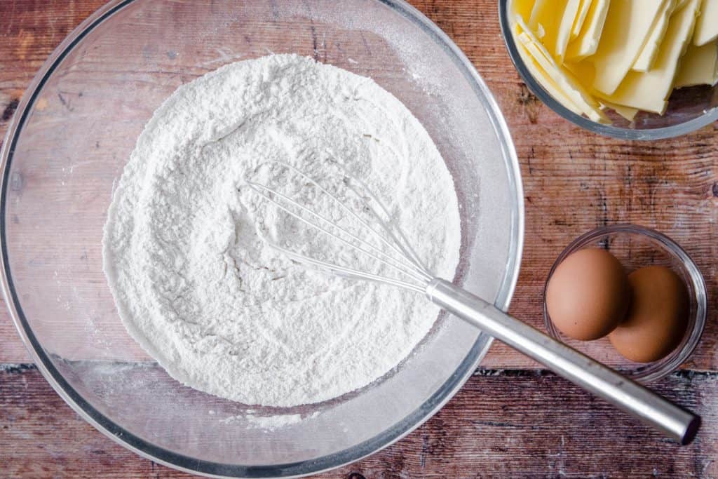 flours in a mixing bowl whisked together for gluten free pastry