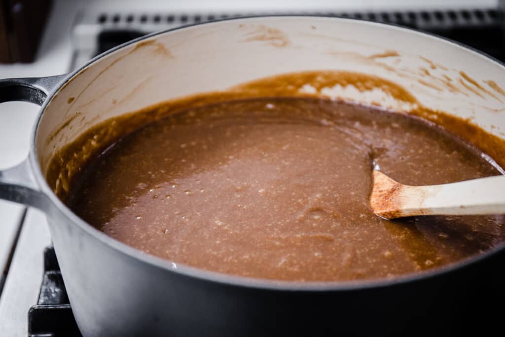 homemade brown sauce cooking in a large pan