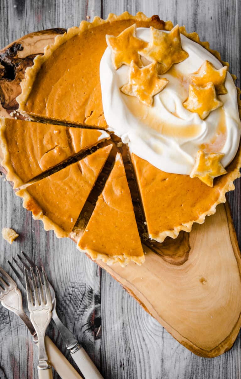 overhead image of pumpkin pie with slices cut out