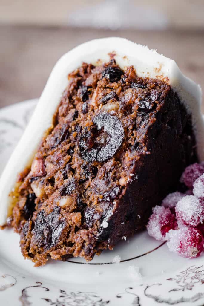 Close up of cut slice of Christmas Cake on a plate