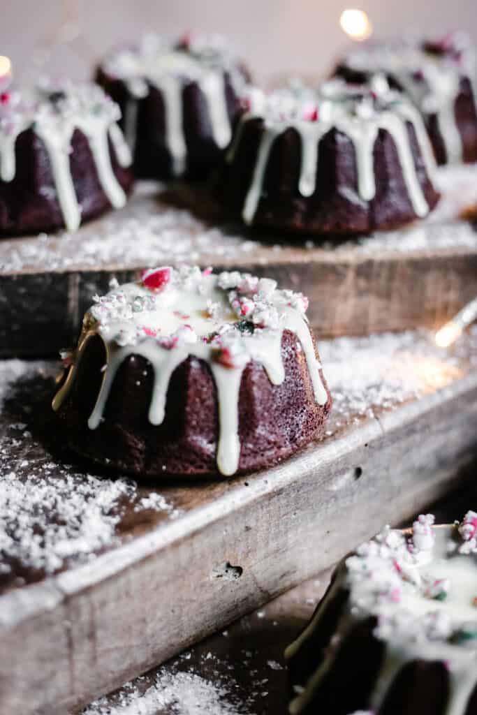 Mini Chocolate Bundt Cakes on wooden boards surrounded by fairy lights