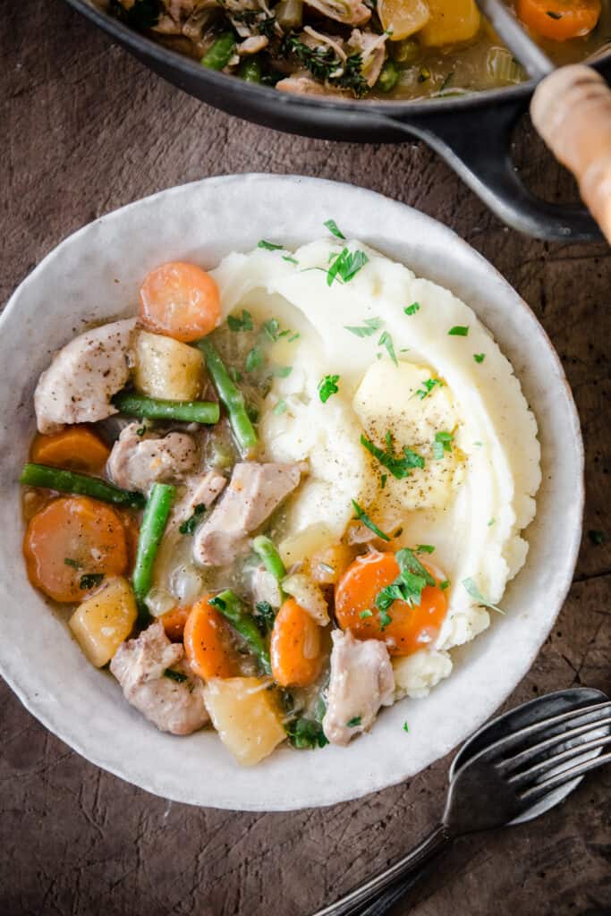 Chicken Casserole in a bowl with mashed potato