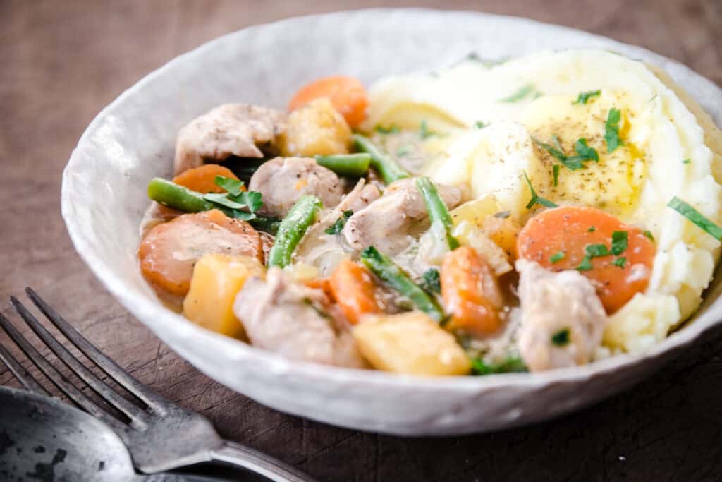 Chicken Casserole in a bowl with mashed potato