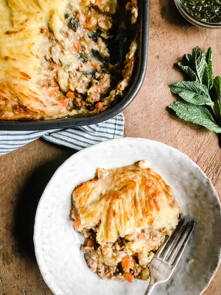 A dish of Shepherds Pie with portion taken out and then in a bowl next to it.