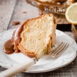 Slice of gluten-free lemon bundt on plate with fork.