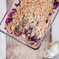 A glass dish of Coconut Crisp with a spoonful taken out
