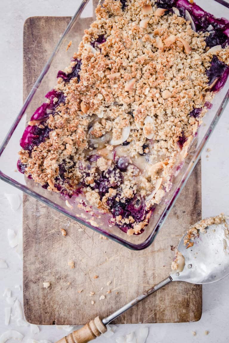 A glass dish of Coconut Crisp with a spoonful taken out