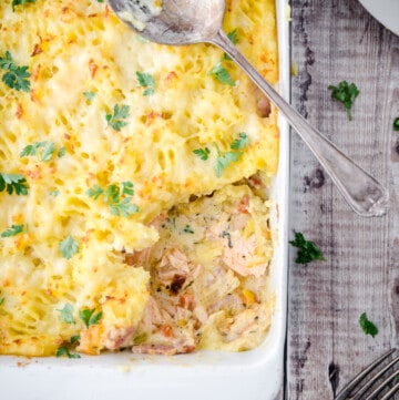 salmon pie with portion scooped out.
