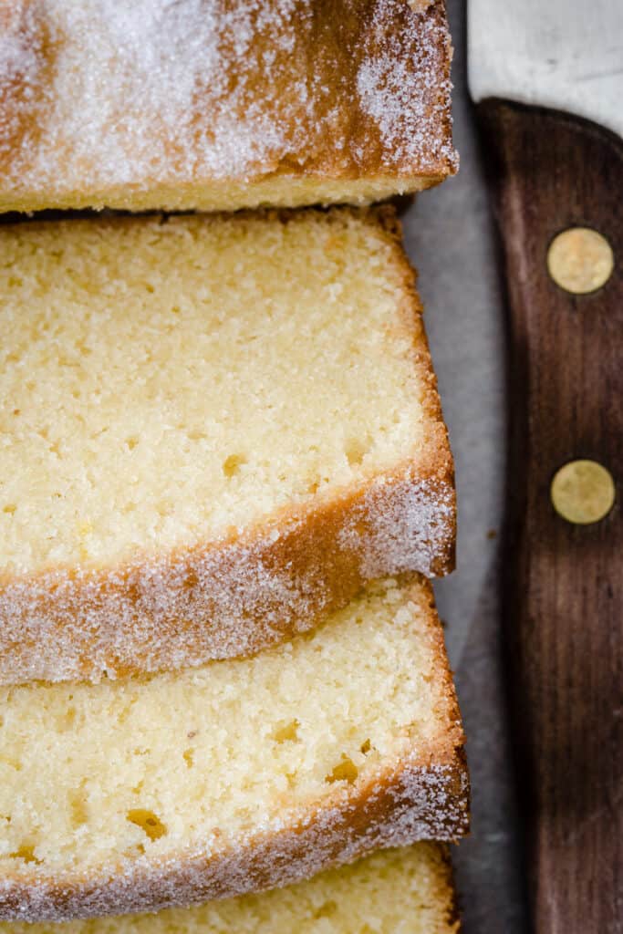 Sliced Rice Flour Madeira Cake next to knife