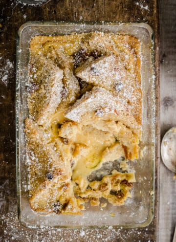 bread and butter pudding in a serving dish with a portion removed