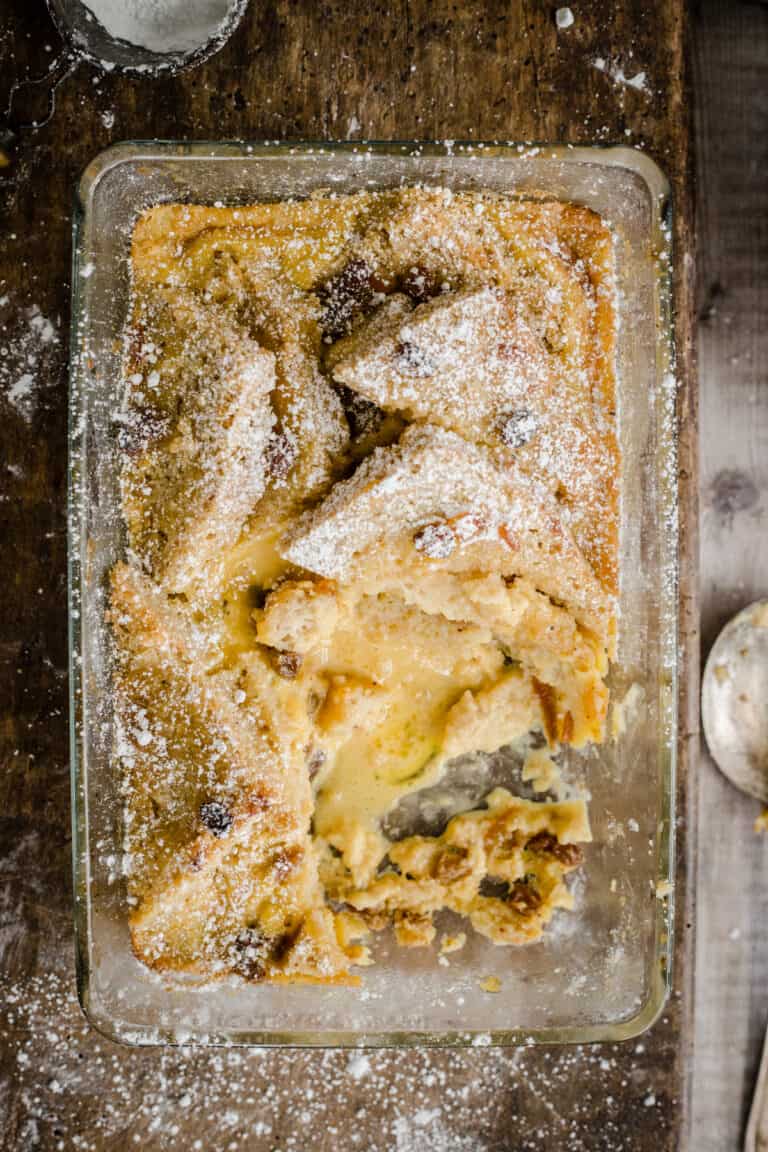 bread and butter pudding in a serving dish with a portion removed