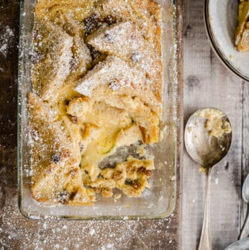 bread and butter pudding in a serving dish with a portion removed