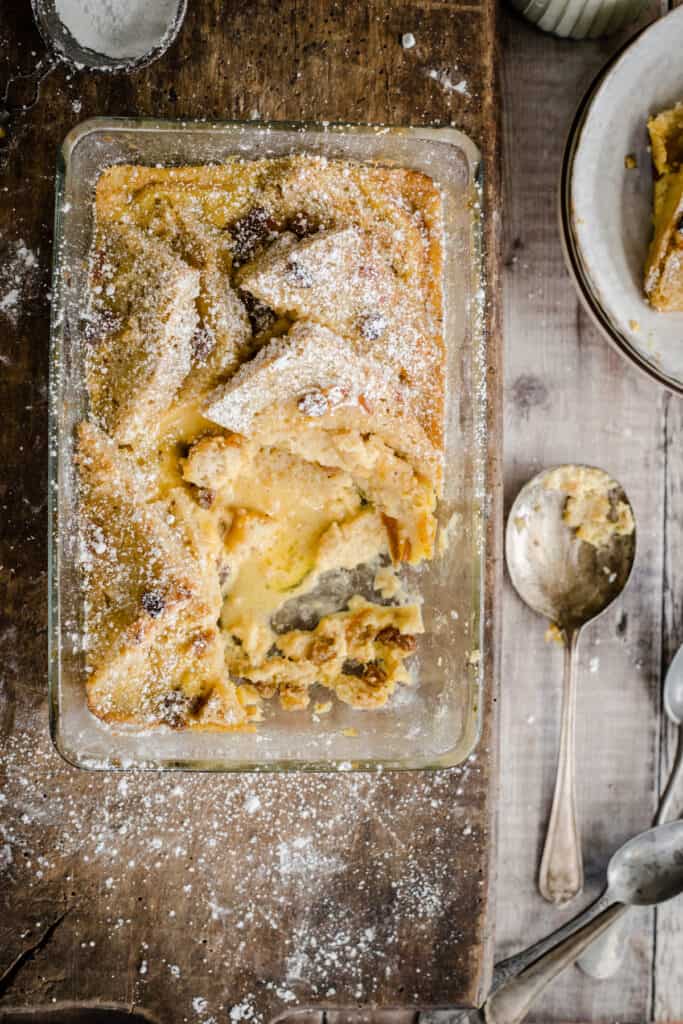 bread and butter pudding in a serving dish with a portion removed