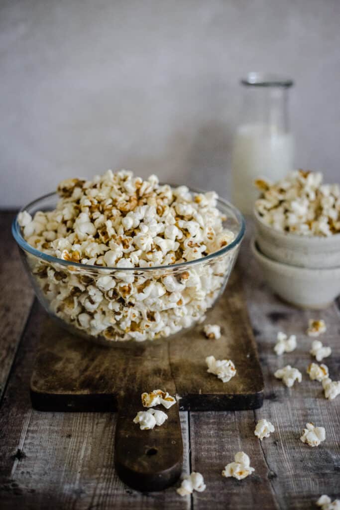 popcorn in a bowl on a board
