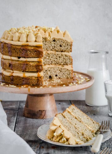 banana cake on a plate in front of cake on a stand