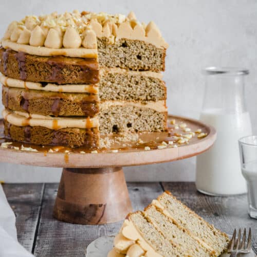 banana cake on a plate in front of cake on a stand