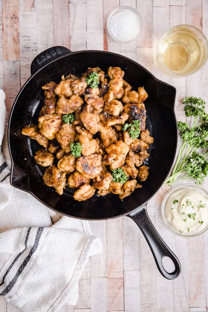 Gluten-Free Fried Popcorn Chicken in a cast iron skillet on table