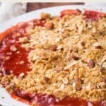 strawberry gooseberry crumble pin with images of the crumble above and below the title of the recipe