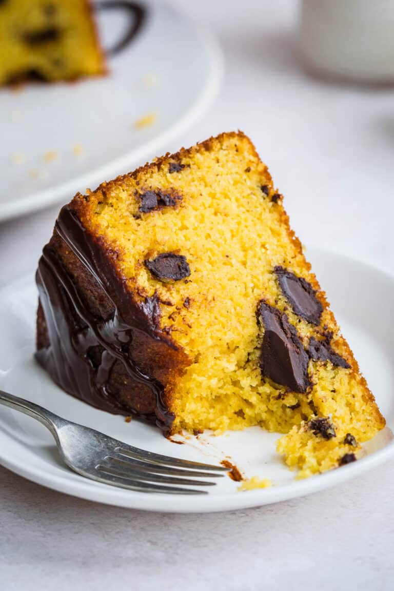 slice of cake on a plate with forkful taken out