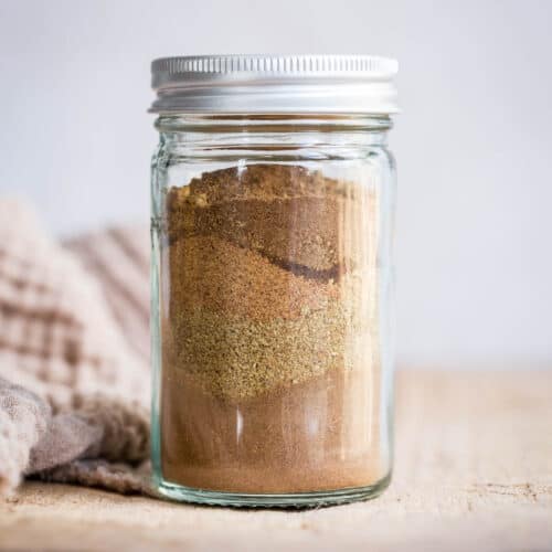 Spices in a jar on a wooden board