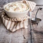 Bowl of bread sauce next to spoon.