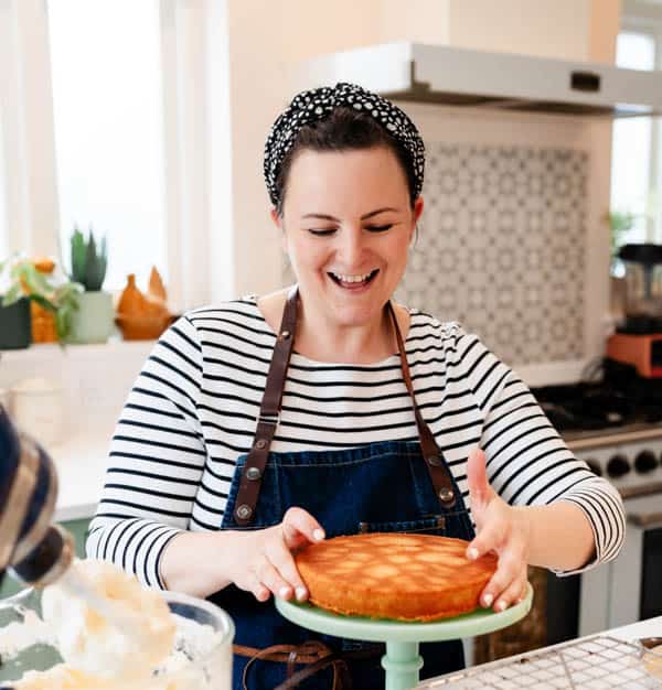 Georgina Hartley smiling and placing cake on cake stand