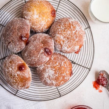 gluten free doughnuts piled on a wire rack
