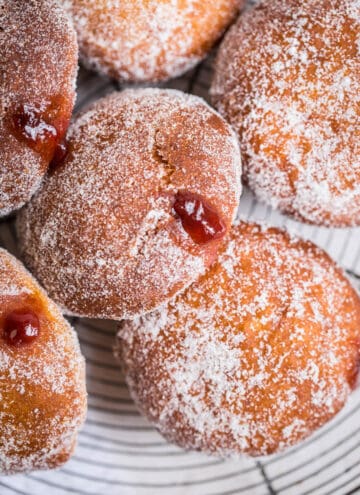 gluten free jam doughnut with jam pouring out of the hole