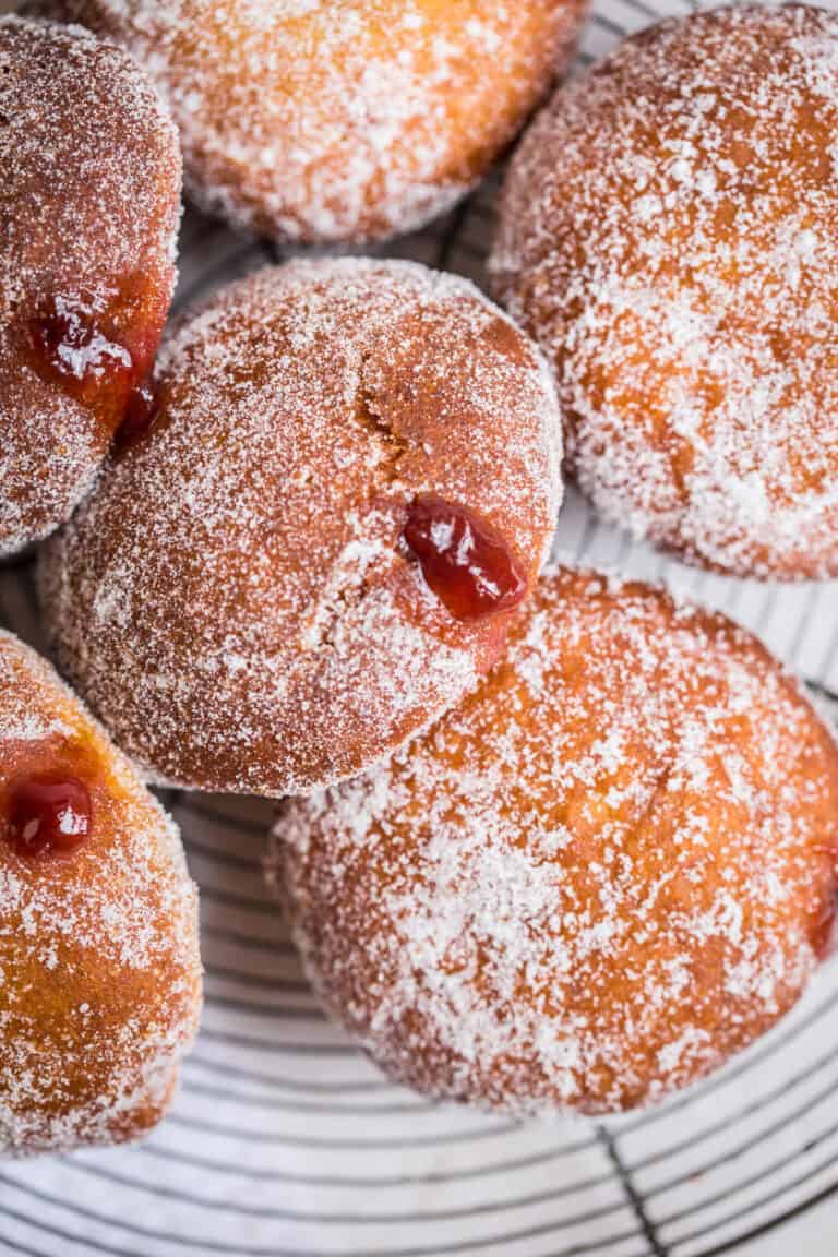 gluten free jam doughnut with jam pouring out of the hole