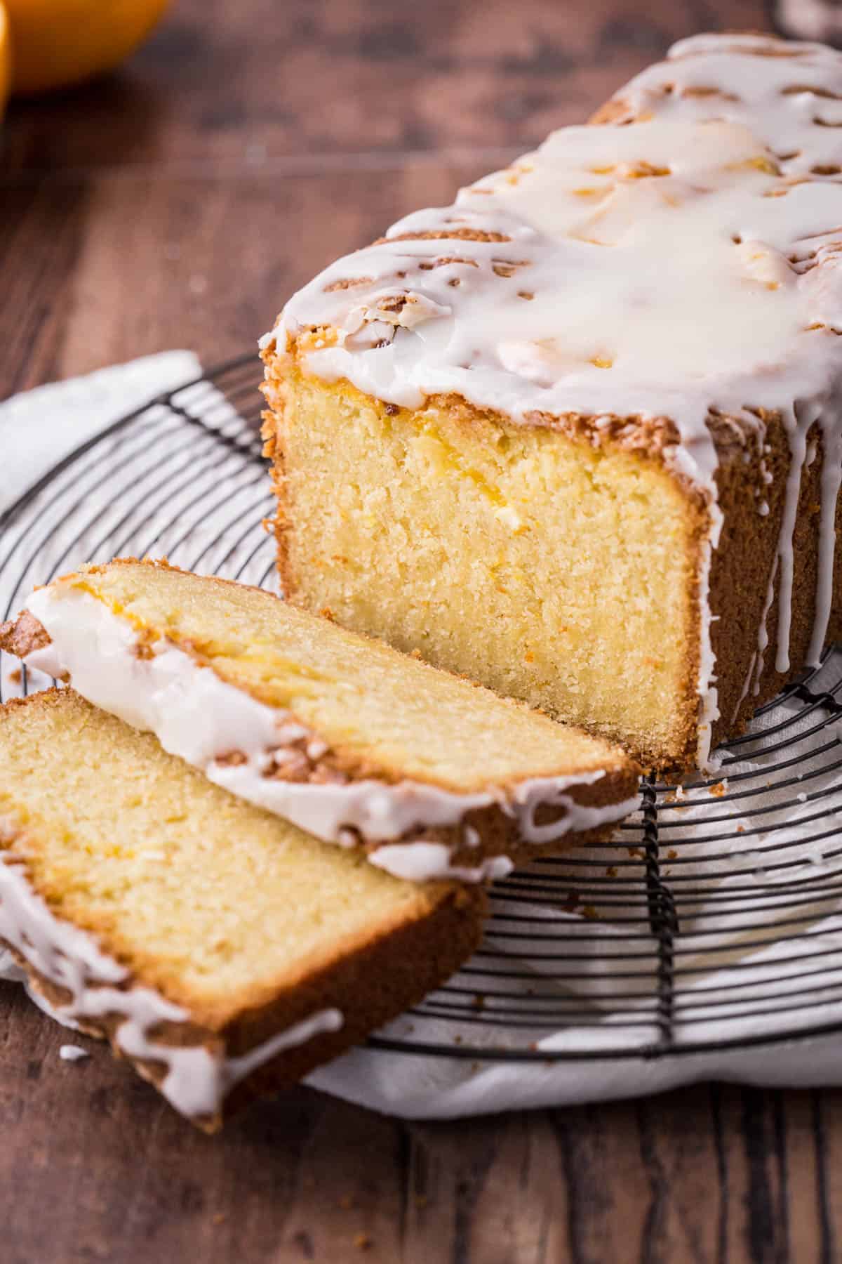 Sliced gluten-free orange cake on a wire rack.