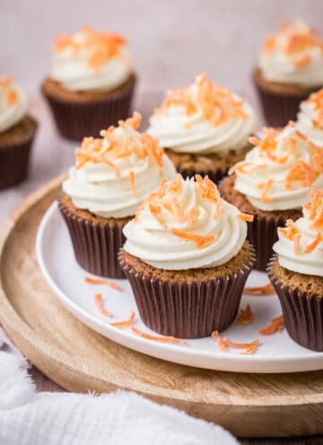 Decorated Carrot Cake Cupcakes on a plate.