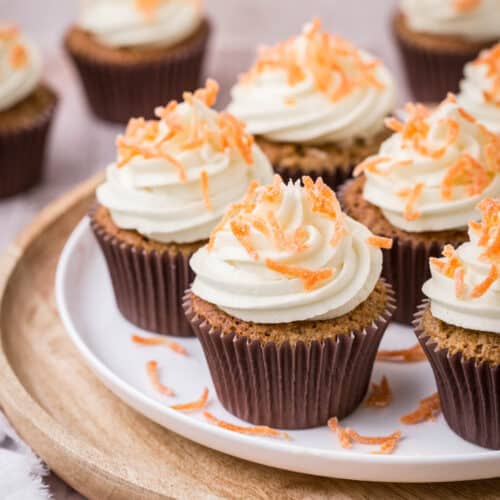 Decorated Carrot Cake Cupcakes on a plate.