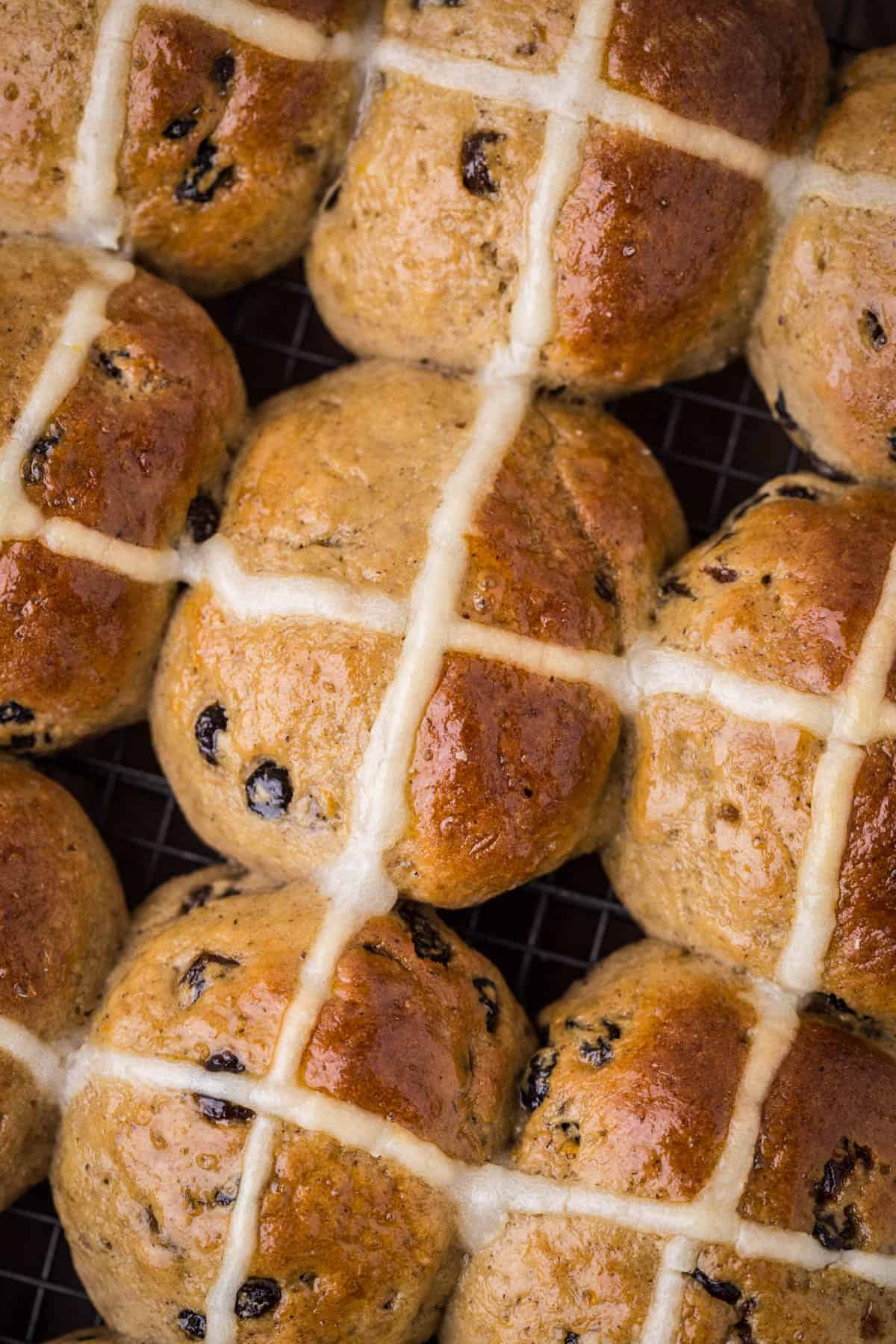 Hot Cross Buns closely packed together fresh from the oven.