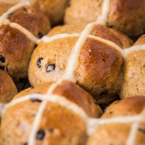 Hot Cross Buns closely packed together fresh from the oven.