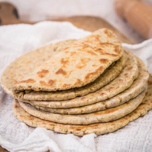 A pile of Gluten-Free Flatbreads. The top one is softly folded in half.