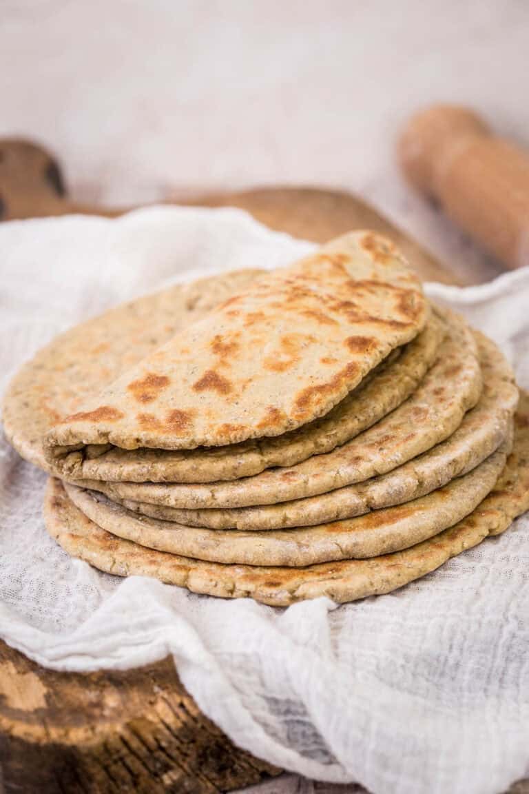 A pile of Gluten-Free Flatbreads. The top one is softly folded in half.