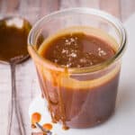 salted caramel sauce in glass jar, drizzling down jar.