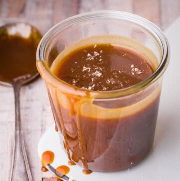 salted caramel sauce in glass jar, drizzling down jar.
